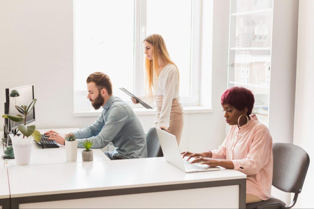 Employees working together in a bright office.