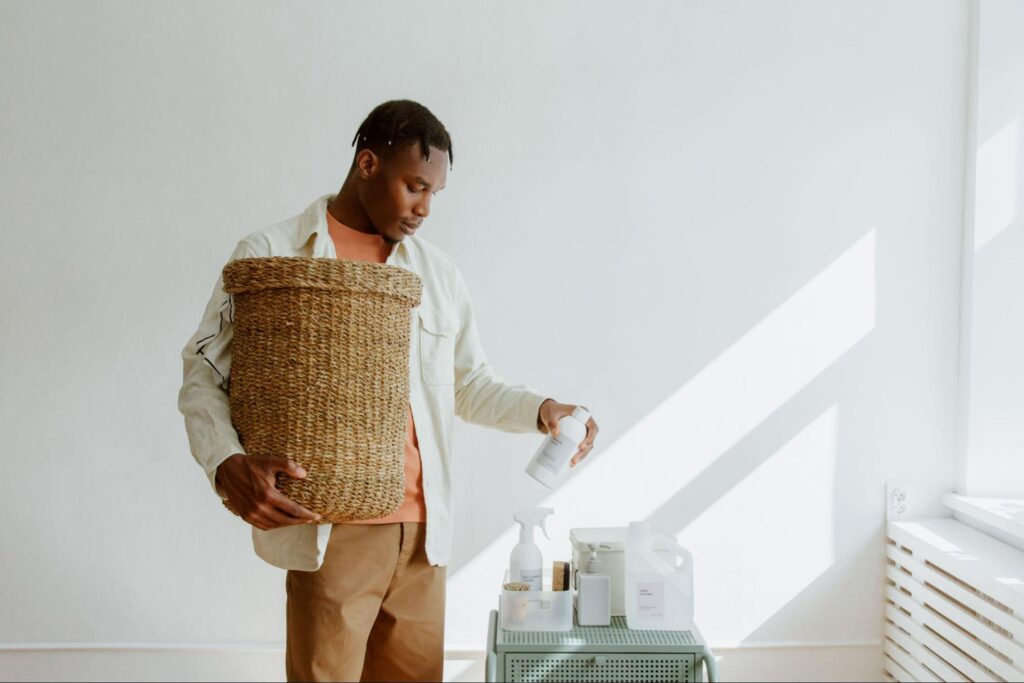 Man organising cleaning products as part of a regular household cleaning routine.
