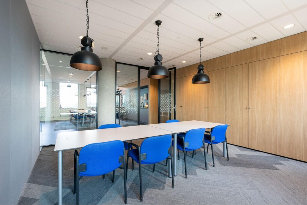 Bright clean meeting room with table and chairs.