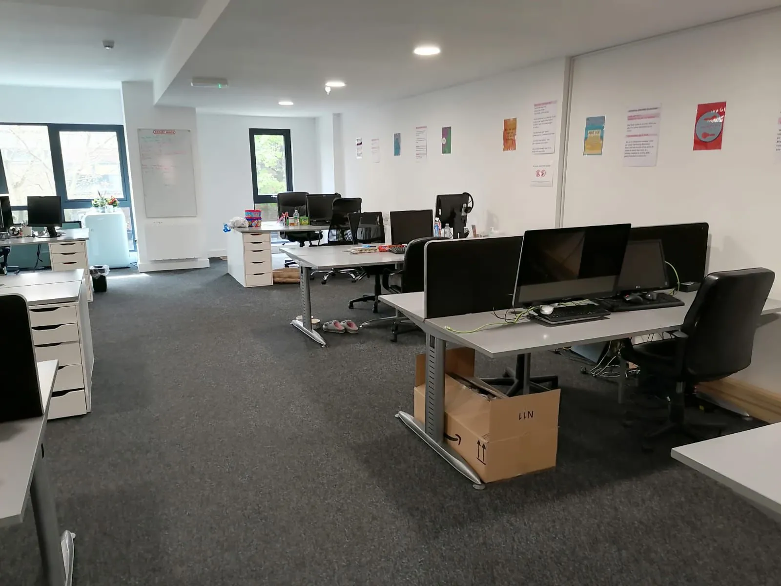 Modern office with rows of desks and monitors, the kind of space covered by our commercial cleaning Swansea service.